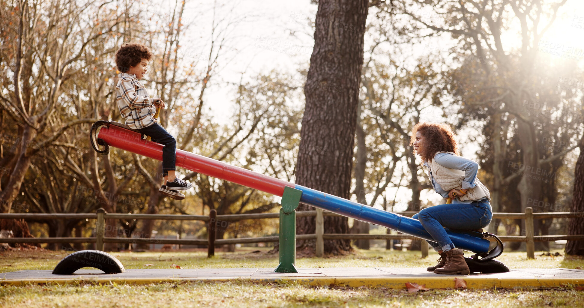 Buy stock photo Park, mother and child with seesaw, playground and game with family balance and holiday with parent. Support, love, care with young boy and woman together with joy, bonding and smile in autumn