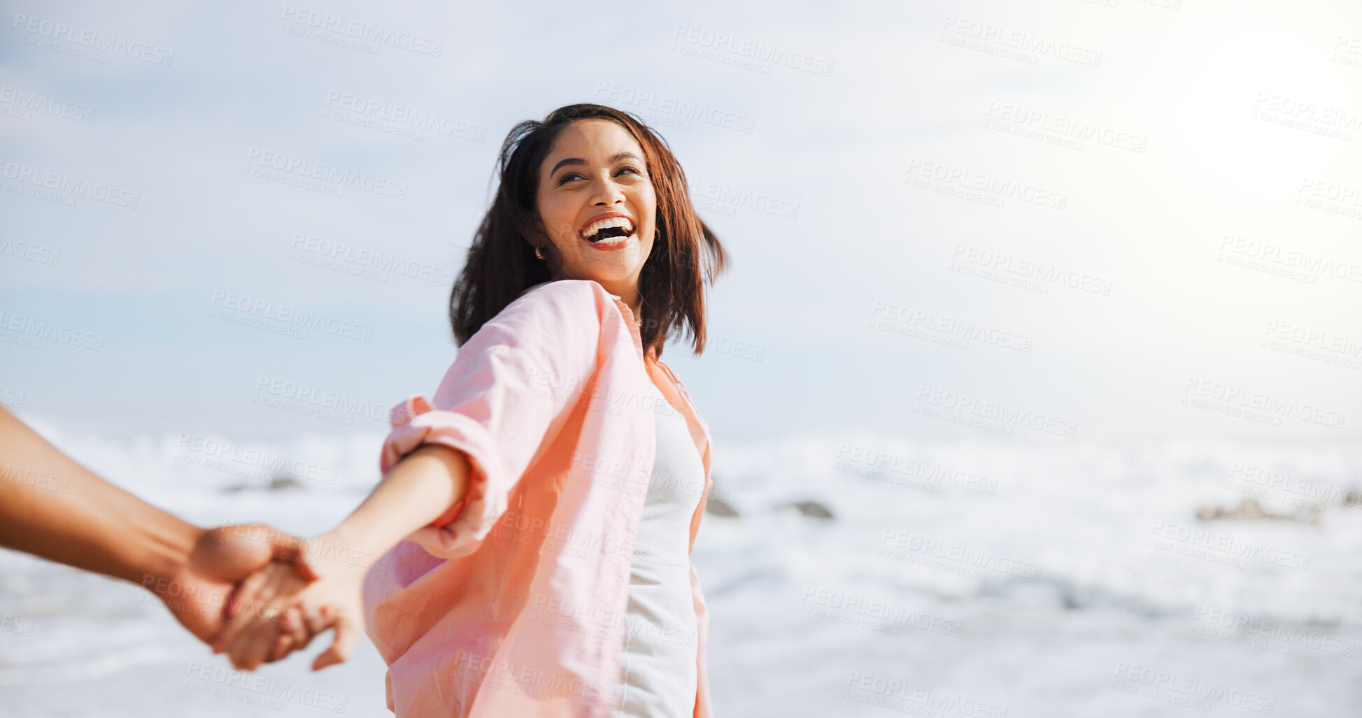 Buy stock photo Love, holding hands and laugh with couple at beach for travel destination, summer and honeymoon vacation. Relax, tropical and adventure with woman on date for holiday, bonding and romance together