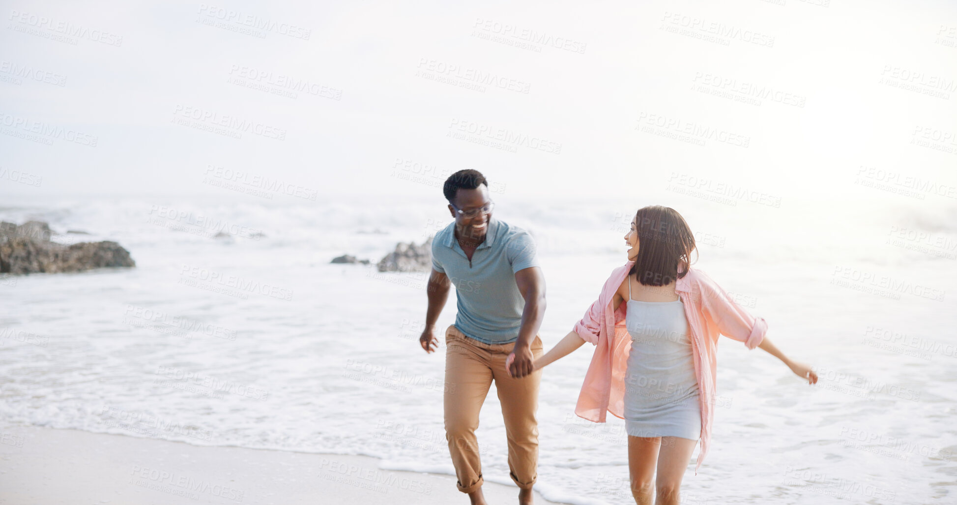 Buy stock photo Happy, holding hands and walking with couple at beach for travel destination, summer and honeymoon vacation. Relax, tropical and adventure with man and woman for holiday, bonding and romance together