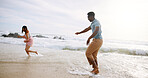 Happy, sand and couple running at the beach for holiday and summer vacation with travel by ocean. Hawaii, fun and tropical with sea water and people on an island with freedom and sunshine outdoor