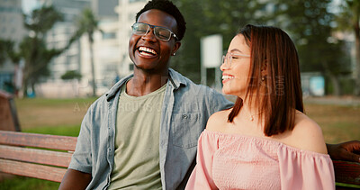 Buy stock photo Laughing, love and couple on bench in park for outdoor fun, bonding and care with interracial relationship. Romance, happy man and woman on date with smile, relax and calm weekend holiday together