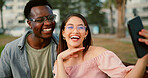 Laughing, selfie and couple on bench in park with fun memory, social media post and interracial relationship. Love, photography and happy man with woman on romantic date with outdoor bonding together