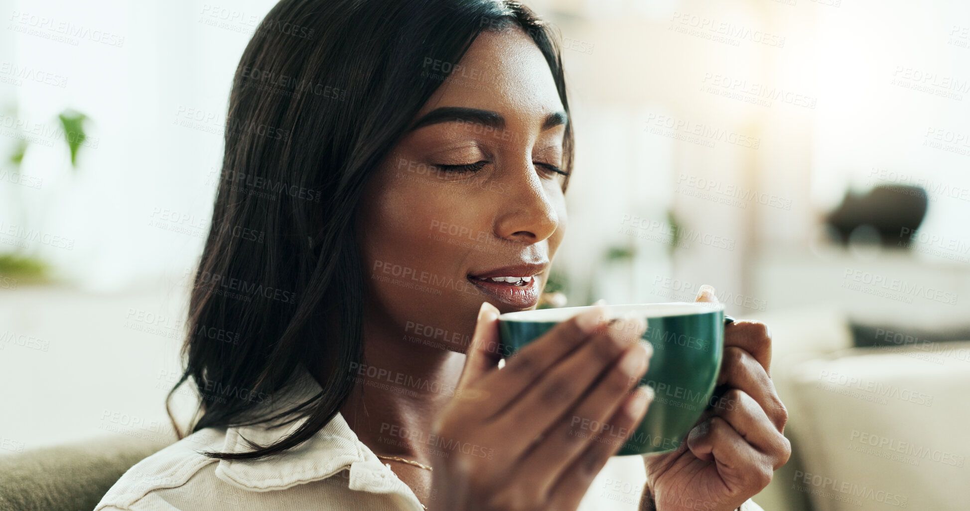 Buy stock photo Coffee, relax and scent with Indian woman on sofa in living room of home for break or caffeine. Aroma, brew and fresh with happy person smelling beverage in mug for afternoon or morning wellness