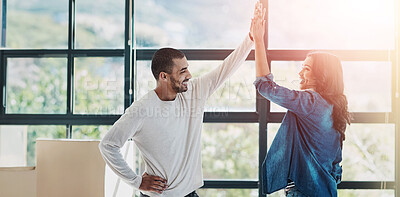 Buy stock photo Shot of a happy young couple moving into their new home together