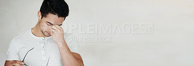 Buy stock photo Studio shot of a young man looking stressed against a light background