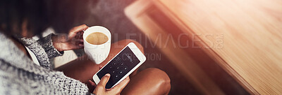 Buy stock photo Shot of an unidentifiable young woman using her cellphone while enjoying a cup of coffee at home