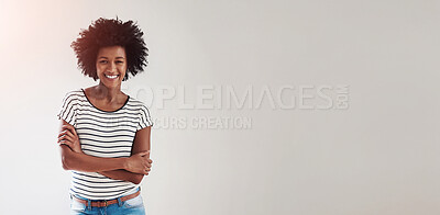 Buy stock photo Portrait of an attractive and happy young woman wearing a striped sweater and denim shorts indoors