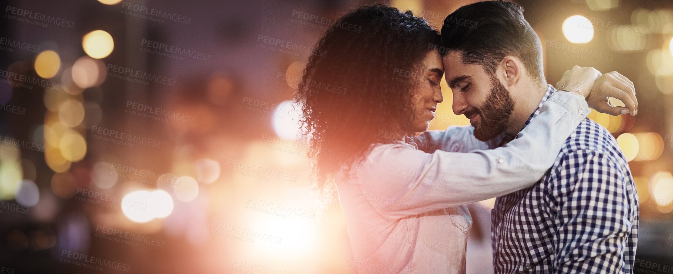 Buy stock photo Shot of an affectionate young couple out on a date in the city