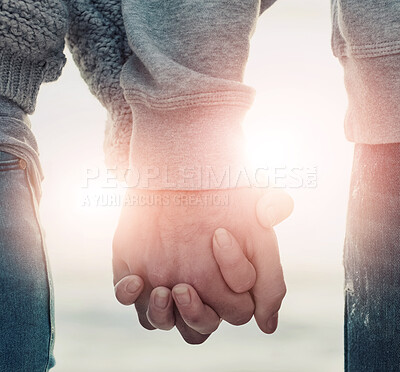 Buy stock photo Shot of an unidentifiable couple holding hands while walking outside