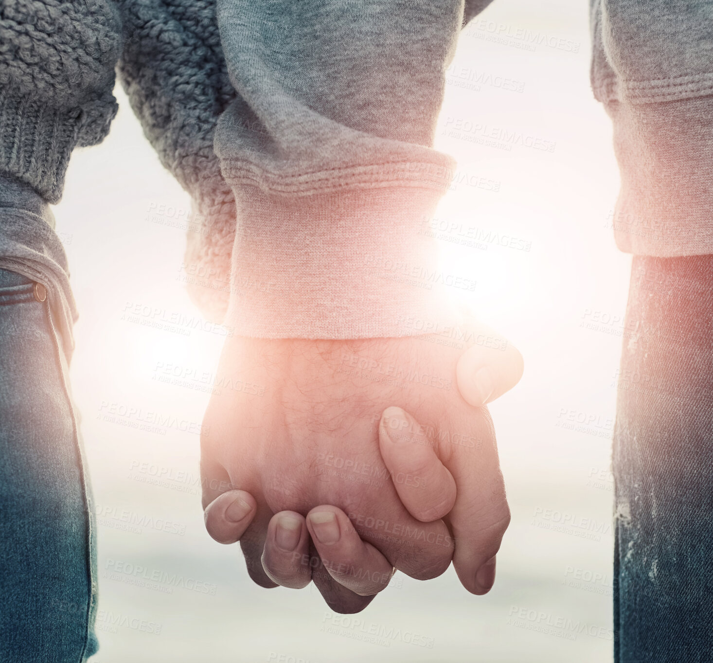 Buy stock photo Shot of an unidentifiable couple holding hands while walking outside