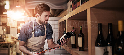 Buy stock photo Shot of a young business owner counting his merchandise