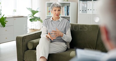 Buy stock photo Psychology, talking and mature woman on sofa for counseling, help or discussion in anxiety. Mental health, support or person on couch with psychologist for consultation, trauma or stress management