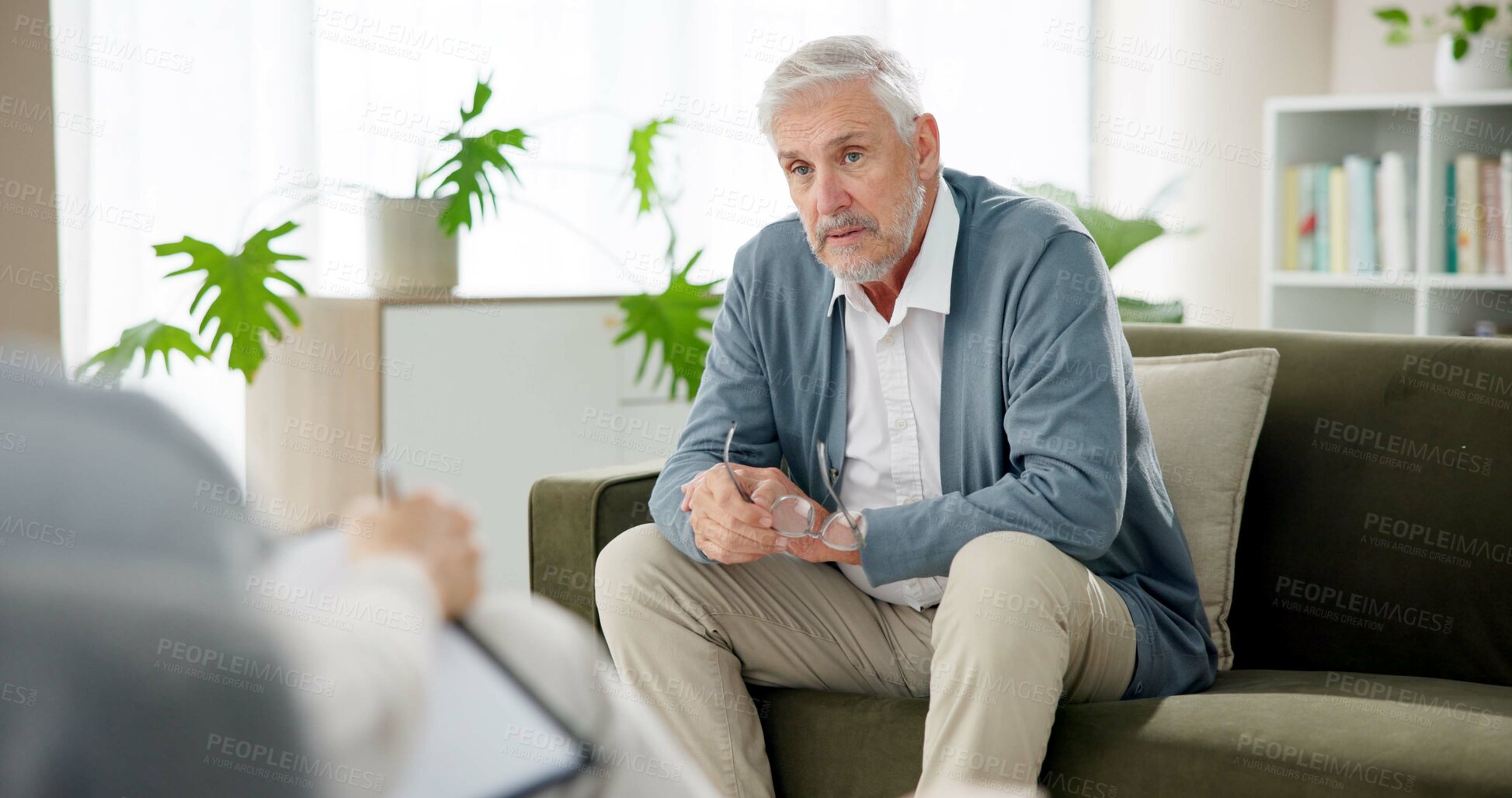 Buy stock photo Psychology, therapist and mature man on sofa for counseling, help or advice for anxiety. Mental health, support or sad person on couch with psychologist for consultation, trauma or stress assessment