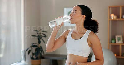 Buy stock photo Home, woman and drinking water for detox after yoga, practice and mindfulness session for health. Fitness, female person and yogi on break with beverage bottle, wellness or hydration with mineral H2O