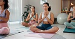 Meditation, zen and prayer hands with women in class for mindfulness, health and wellness. Yoga balance, spiritual and healing aura with people and holistic practice for relax, awareness or energy