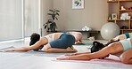 Yoga, class and women in gym for fitness, posture and stretching for warm up. Pilates session, people and childs pose in local wellness center for spiritual healing, stress relief and healthy body