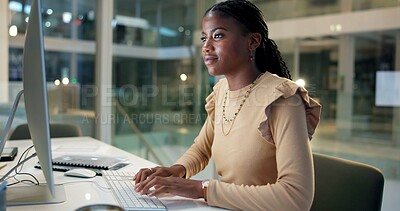 Buy stock photo Business, black woman and typing on computer in office at night with online trading and reading NFT finance portfolio. Professional, trader and happy on pc with stock market trends and cryptocurrency