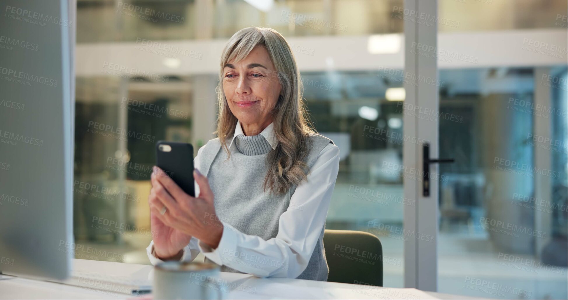 Buy stock photo Mature woman, office and checking phone for online chat, business communication or contact at night. Overtime, smartphone and senior businesswoman reading email, review or message at digital agency