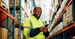 Phone, worker and black man in warehouse for logistics, distribution or stock inspection on shipping app. Mobile, factory or happy engineer check inventory for export, supply chain or quality control