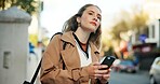 Woman, phone and waiting in street to travel with taxi app, transport and morning commute in city. Professional, person and smartphone for cab location, trip details and ride service on road sidewalk