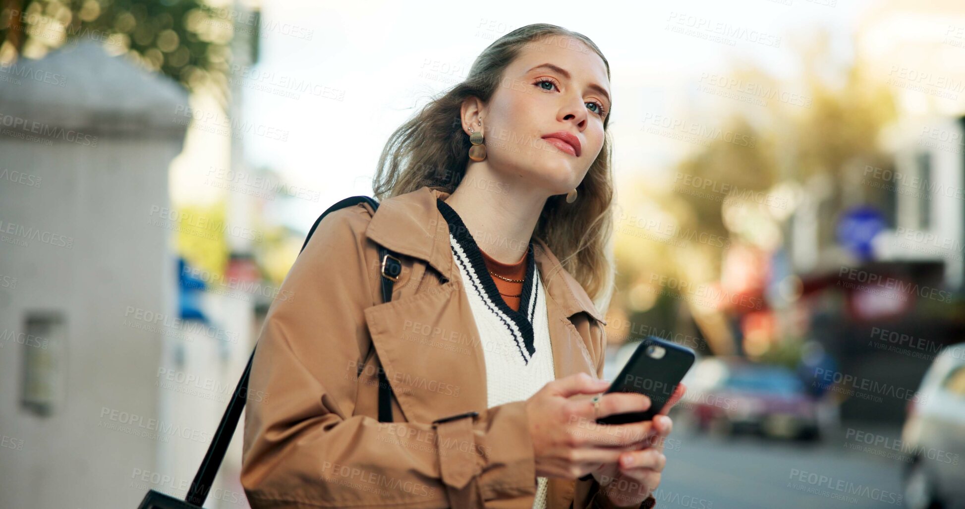 Buy stock photo Woman, phone and waiting in street to travel with taxi app, transport and morning commute in city. Professional, person and smartphone for cab location, trip details and ride service on road sidewalk