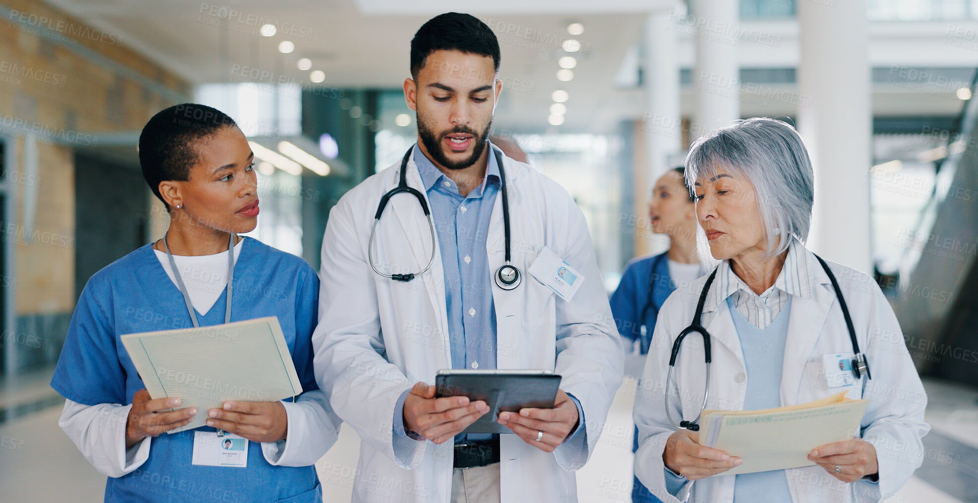 Buy stock photo Walking, tablet and doctors in hospital in discussion for medical service, consulting and surgery schedule. Healthcare, clinic and men and women on digital tech for telehealth, website and research
