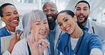 Doctors, selfie and happy with diversity at hospital with ok symbol, peace sign and good service in portrait. People, medical staff and smile with icon, emoji and support at healthcare job in Canada