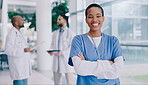 Doctor, black woman and arms crossed with smile in portrait at hospital for medical career. Person, surgeon and healthcare professional in corridor at clinic for wellness, services and job in Mexico