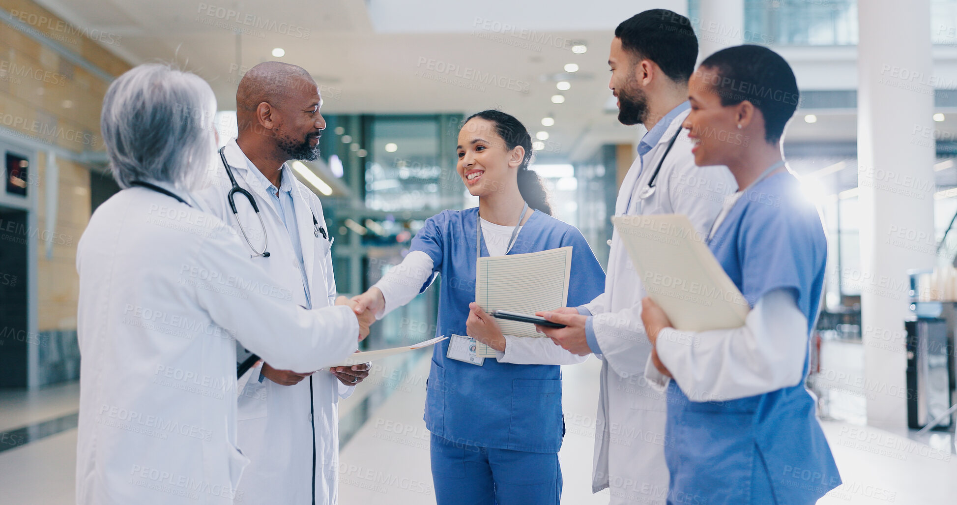 Buy stock photo Woman, doctors and handshake with team in hospital for welcome, introduction and happy for success in corridor. People, medical staff and shaking hands with diversity, support and group at clinic