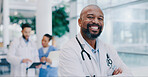 Doctor, black man and arms crossed with smile in portrait at hospital with pride for medical career. Person, happy and healthcare professional in corridor at wellness clinic, service and job in Kenya