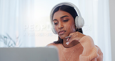 Buy stock photo Laptop, learning and music with Indian woman in home office for online study or remote work. Computer, listening and reading with freelancer in apartment for future planning or problem solving