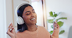 Dance, music and smile with Indian woman in home office for online study or remote work. Headphones, radio and streaming with happy freelance employee in apartment for break or complete task