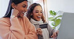 Talking, online shopping and friends with card, home and bonding in living room, laughing and discount. Ecommerce, women and payment with credit, digital and choice of purchase, laptop and lounge