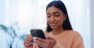 Buy stock photo Home, Indian woman and connection with smartphone for chat, message and communication with contact. House, female person or phone with mobile app for scroll, share reel and online dating with smile