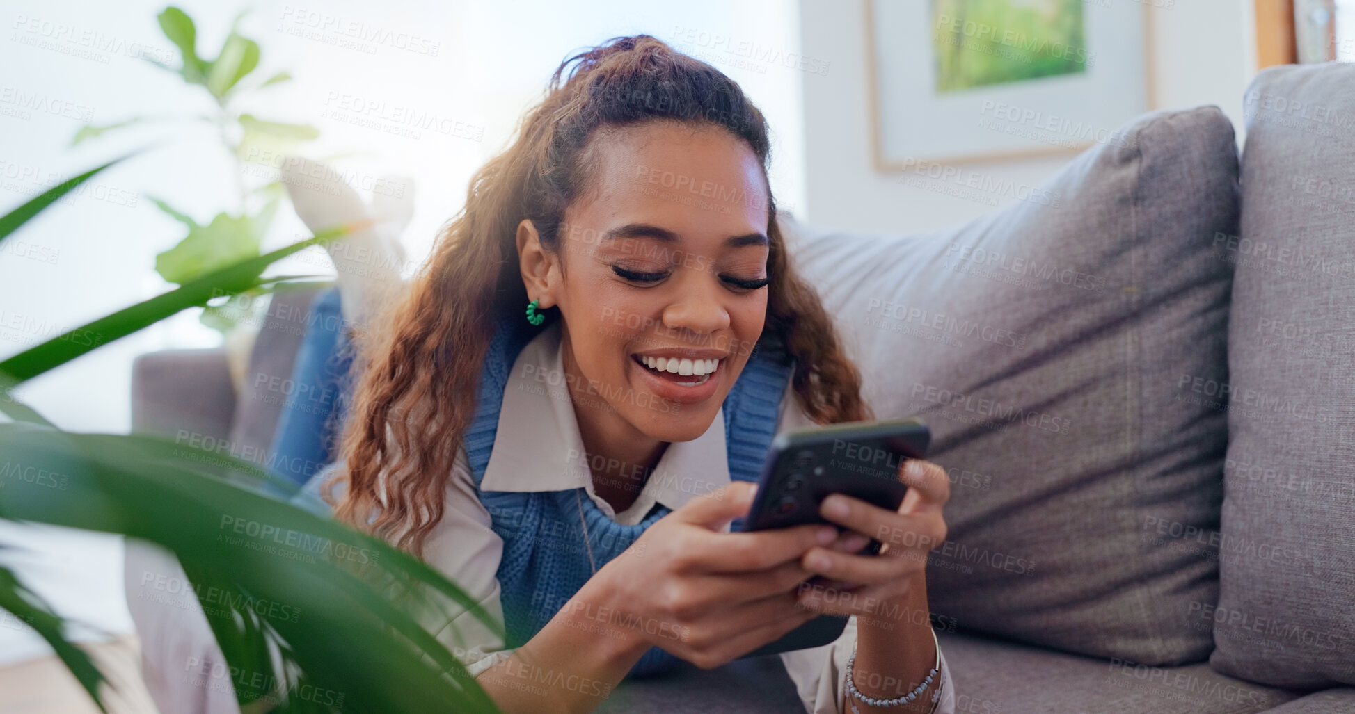 Buy stock photo Woman, sofa and phone with scroll in home for social media browsing, reading ebook or smile for text message. Girl, person or laughing with smartphone on couch for relax or funny comment on blog post