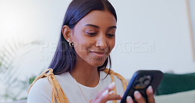 Buy stock photo Girl, sofa and phone with scroll in home for social media browsing, reading ebook and smile for text message. Indian woman, person and happy with smartphone on couch for relax or comment on blog post