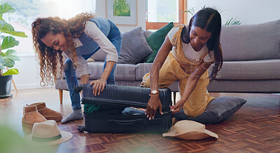 Buy stock photo Packing, smile and suitcase with lesbian couple in living room of home, getting ready for holiday or vacation. Love, luggage and travel with LGBT women in apartment together for break or trip