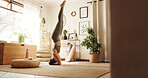 Head stand, pilates and woman in home for exercise, chakra balance or health in morning routine. Wellness, fitness and female person with yoga workout for body strength in living room at apartment.