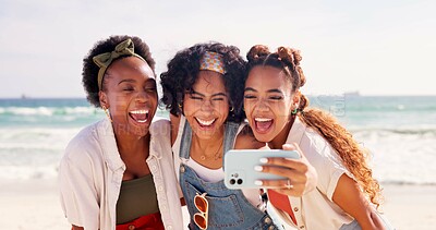 Buy stock photo Happy women, friends and laughing with selfie at beach for funny holiday or summer vacation together. Young, group or female person with smile, hug or humor for picture, memory or moment by ocean