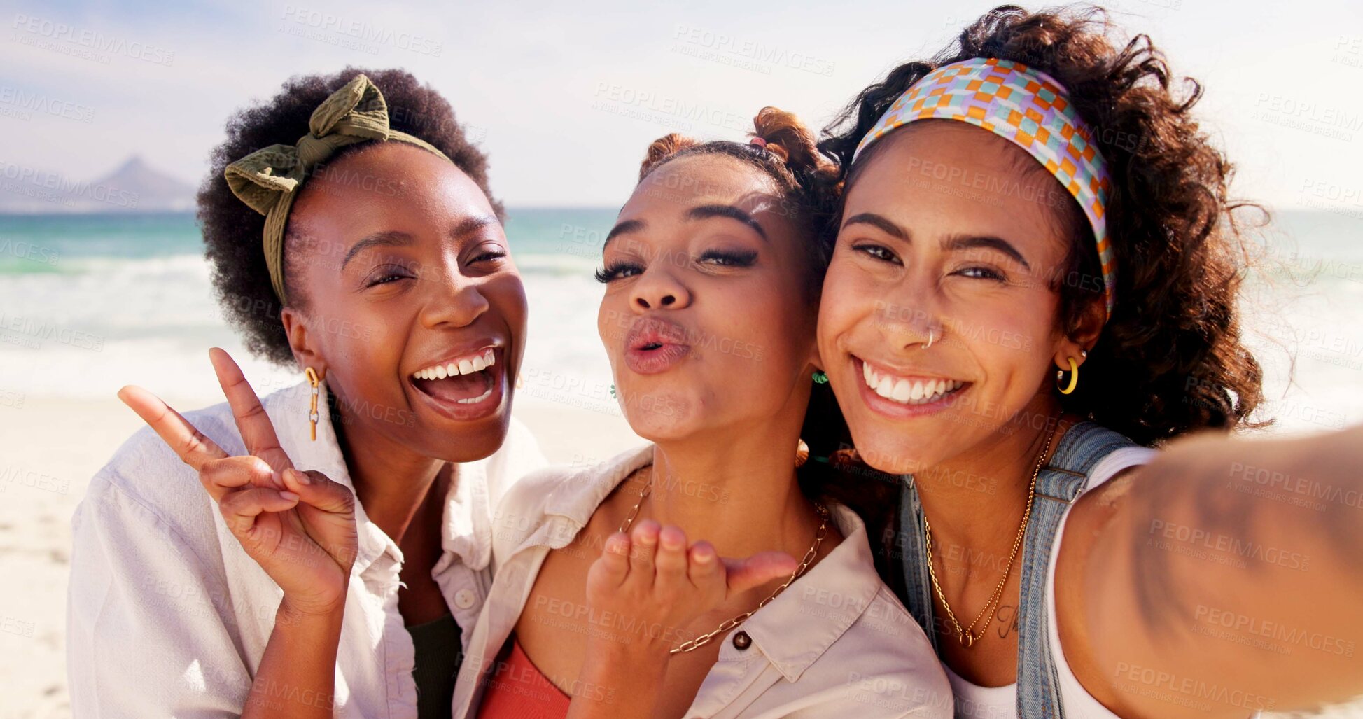 Buy stock photo Happy women, portrait and selfie with peace sign at beach for holiday or summer vacation together. Young, group or female people with smile, kiss or hug in joy for picture, memory or moment by ocean