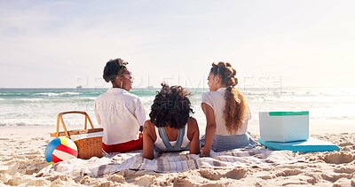 Buy stock photo Women, friends or relax with picnic on beach for summer vacation, holiday or weekend together in nature. Back view, group or people enjoying peaceful day with blanket or basket on sand by ocean coast