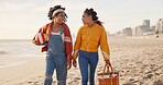 Friends, beach and walking together on sand, outdoor freedom and weekend trip to ocean waves. Women, people and travel to sea with picnic basket for vacation, talking and holiday for peace in Dubai