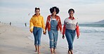 Happy women, walking and holding hands with friends on beach for holiday, weekend or strolling in nature. Young, female person or group with smile for outdoor vacation or social by ocean coast