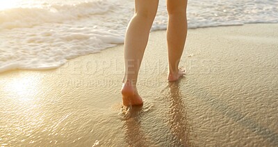 Buy stock photo Person, legs or feet with water on beach, waves or shore for sunny vacation, holiday or weekend getaway in nature. Closeup, walking and foot with sunlight on ocean coast for outdoor stroll by seaside