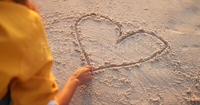 Buy stock photo Woman, hand and drawing heart in sand, outdoor peace and emoji for love on beach vacation. Female person, nature and symbol for romance on weekend trip, back and finger for support or care icon