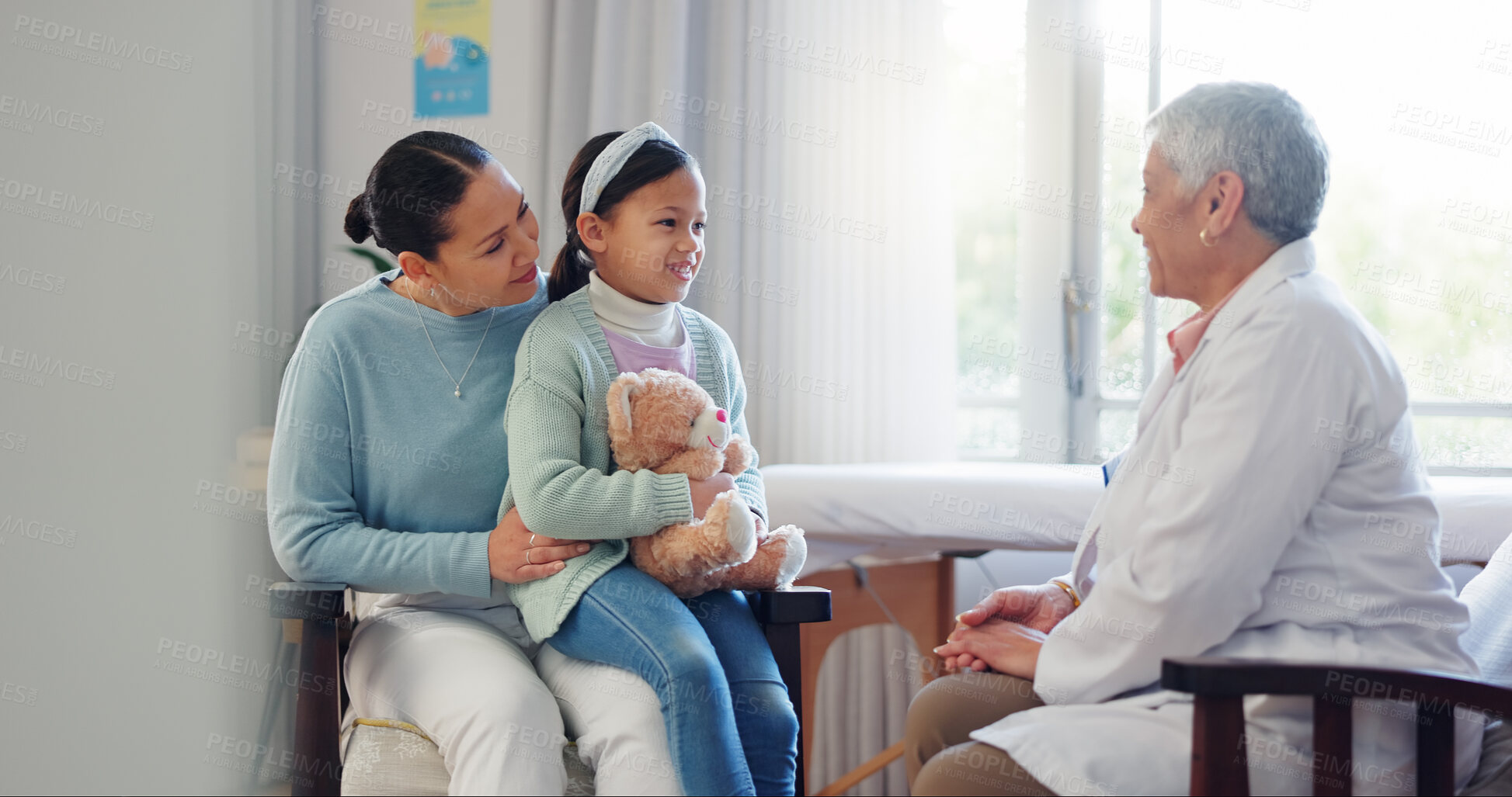 Buy stock photo Pediatrician, child and mom at hospital consultation with help of mature woman and teddy with health check. Smile, clinic and healthcare with exam, young girl and wellness with family doctor and talk