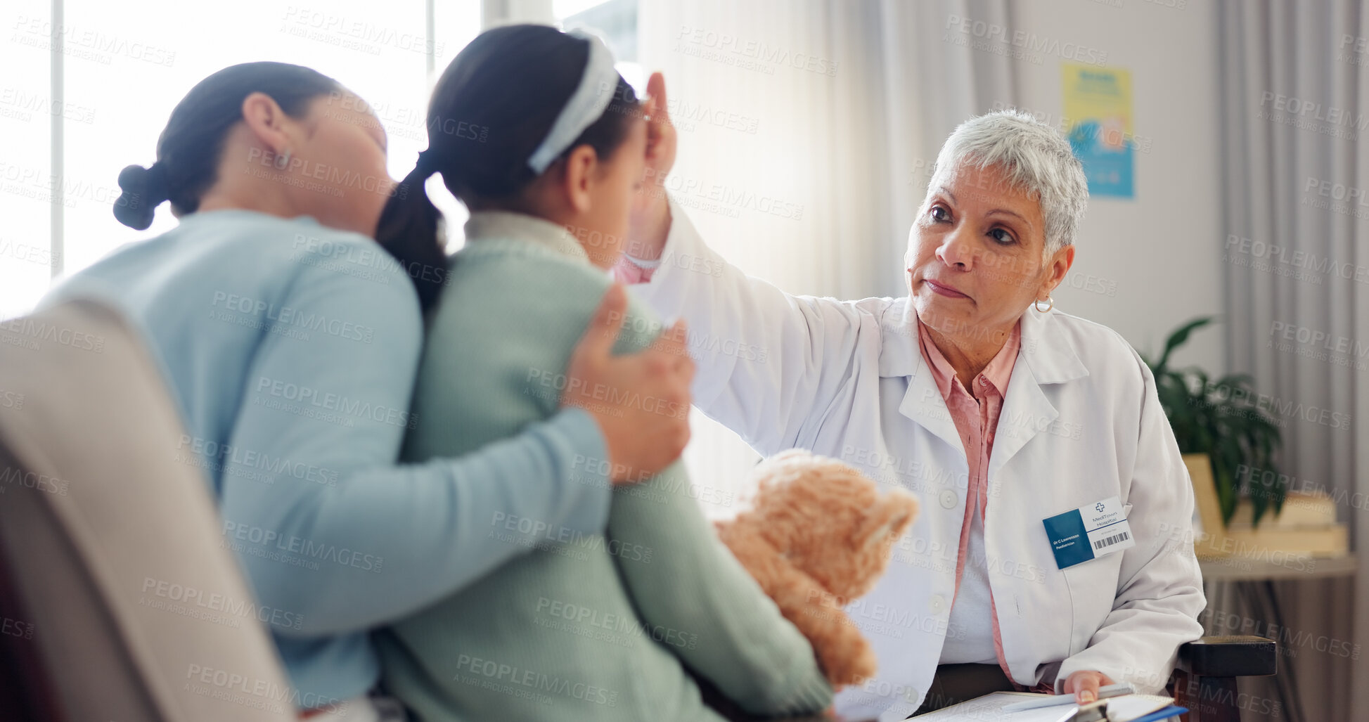 Buy stock photo Doctor, child and check forehead at clinic, pediatrician and sick girl for healthcare assessment. Mature woman, mother support kid and medic for cold diagnosis, fever test and hospital exam for flu