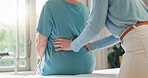 Back pain, physiotherapy and hands of people in office for medical exam, support and injury recovery. Women, physiotherapist and patient with consultation for osteoporosis, rehabilitation or progress