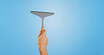 Window, cleaning and hands of person on blue background for housekeeping or maid service. Washing, wipe and isolated cleaner with equipment for glass hygiene, maintenance and disinfection in studio