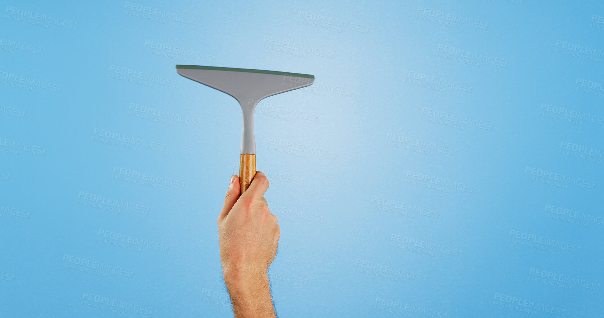 Buy stock photo Window, cleaning and hands of person on blue background for housekeeping or maid service. Washing, wipe and isolated cleaner with equipment for glass hygiene, maintenance and disinfection in studio